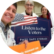 Physicians hold signs that say "Listen to the voters. Pass safe legislation."