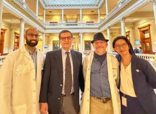 phisicians pose with Georgia Representative Au to promote gun safety legislation