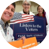 GC4GS physicians hold signs that say "Listen to the voters. Pass safe legislation."